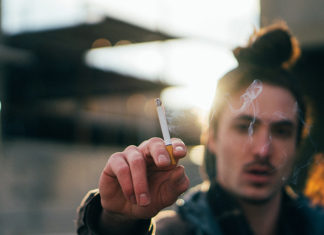 Man Smoking Outside Cafe Warns Against Eating Meat