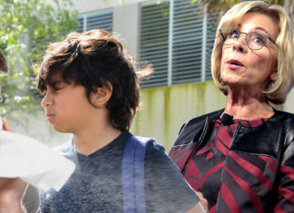 Betsy DeVos Deploys Child Shield to Save Self From Sneezing Man